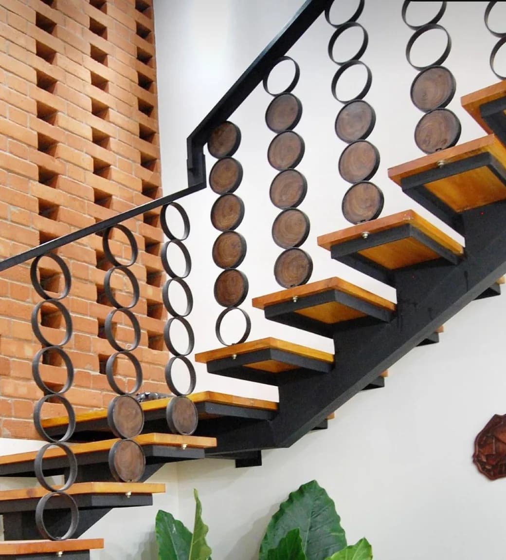 Architectural steel staircase with timber treads and circular balustrade detail